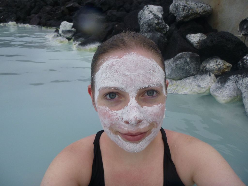 Girl with a mud mask on her face in the Blue Lagoon, Iceland