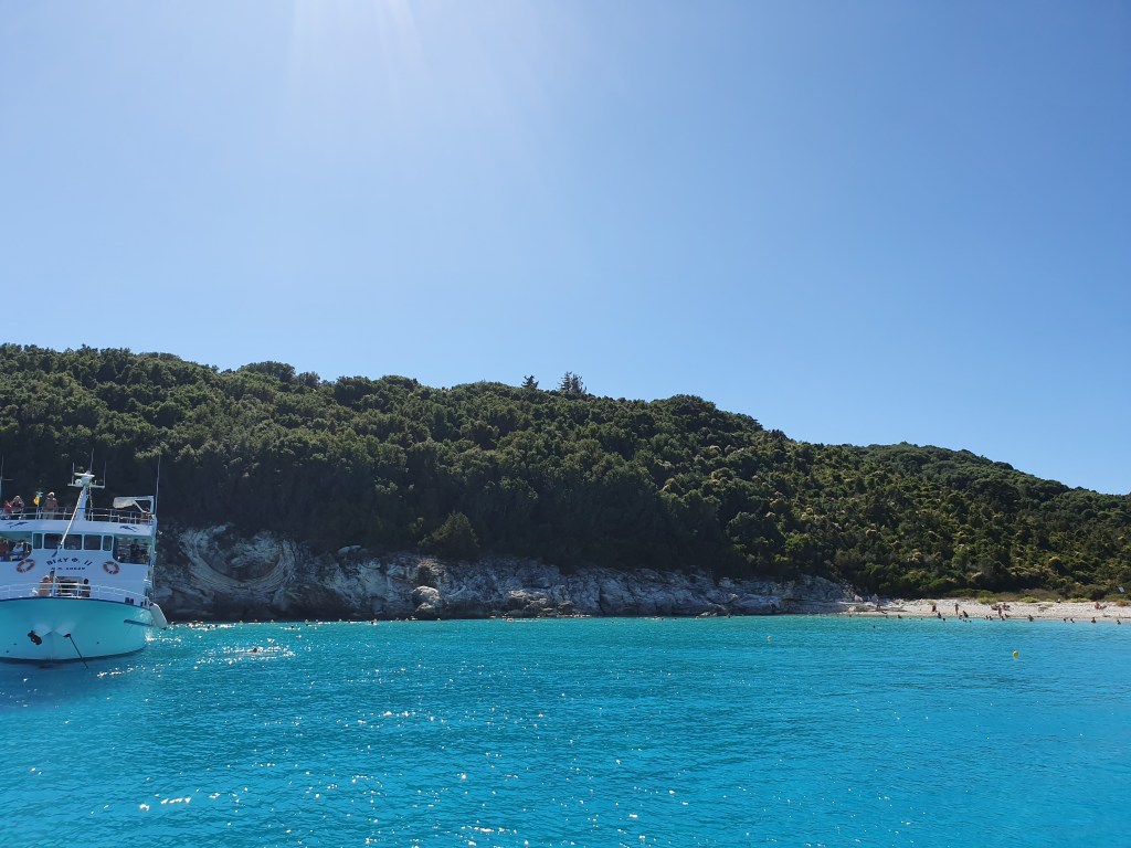 A boat in the sea off the beach of Antipaxos