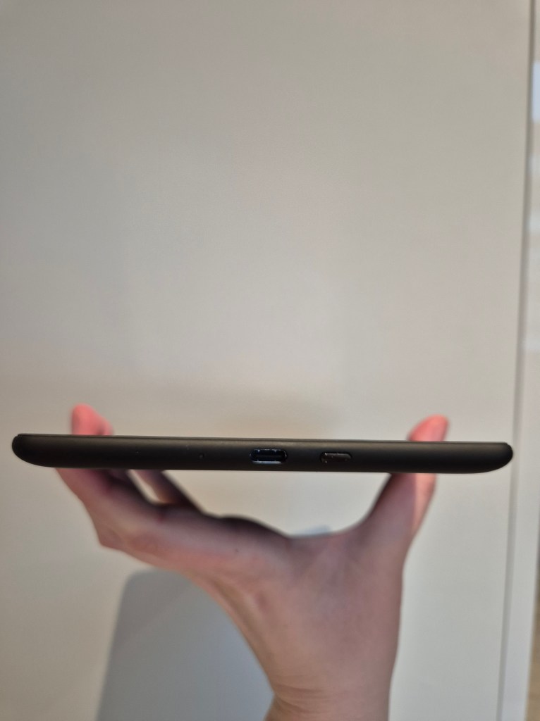 Kindle Paperwhite Signature Edition charger & button view